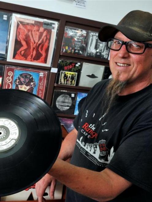 Tony Renouf, owner of Too Tone Records in Northeast Valley, holds a copy of <i>The Dunedin Double...