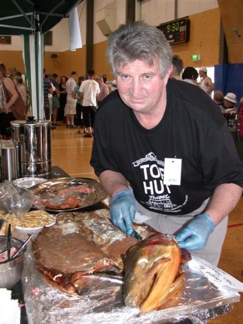 Top Hut bistro owner Mike Darling hands out free smoked fish at the Mackenzie salmon and wine...