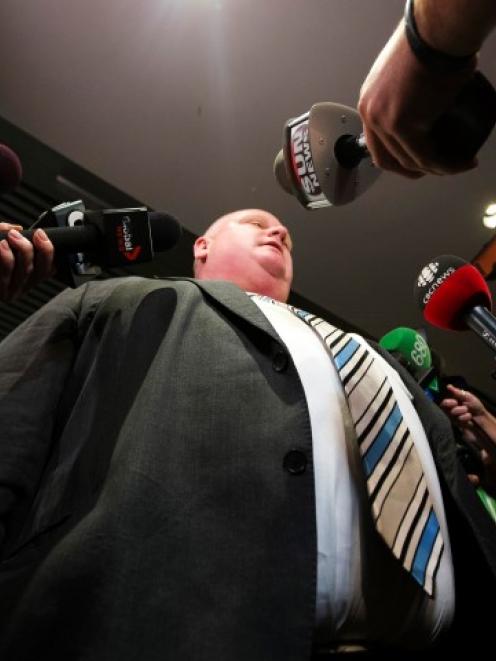 Toronto Mayor Rob Ford makes a statement to the media at City Hall after his press secretary...