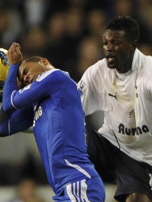 Tottenham Hotspur's Emmanuel Adebayor (R) and Chelsea's Ashley Cole vie for the ball during their...