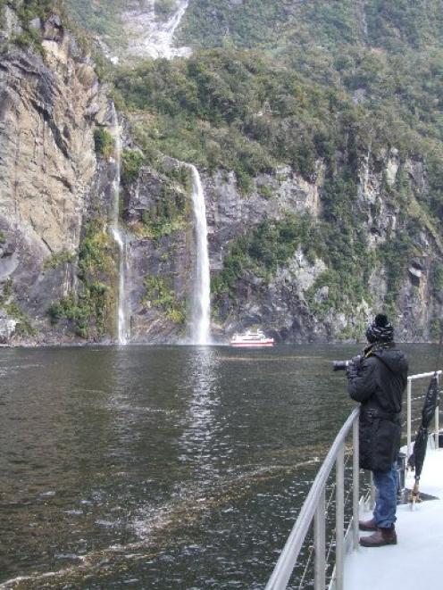 Tourist boats are dwarfed by Milford Sound's many mighty waterfalls. Photo by Bruce Munro