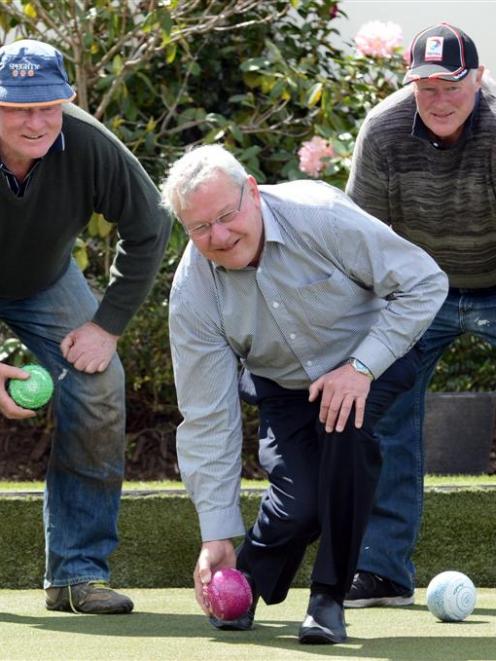Tournament boss Neill Williams is supported by brothers Jim and Terry Scott as he tests the green...
