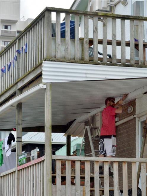 Tradesman Michael Kinraid carries out work on  a balcony in Union St East yesterday at the...
