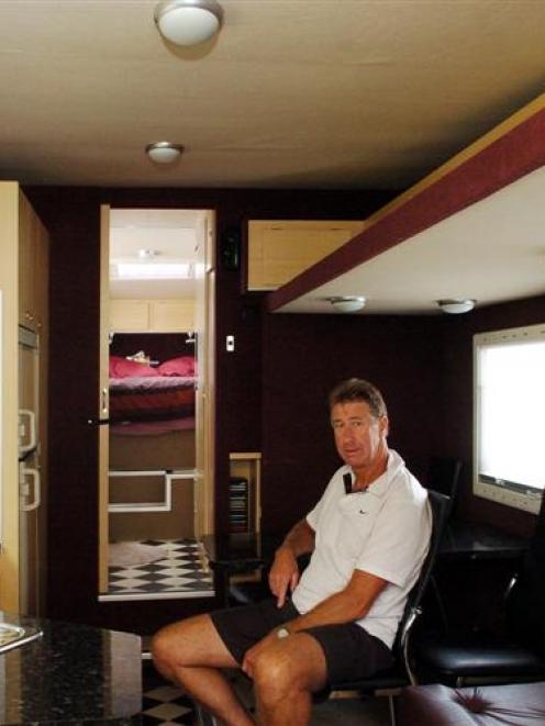 Trevor Nixon relaxes in his campervan, which has all the modern conveniences including toilet....