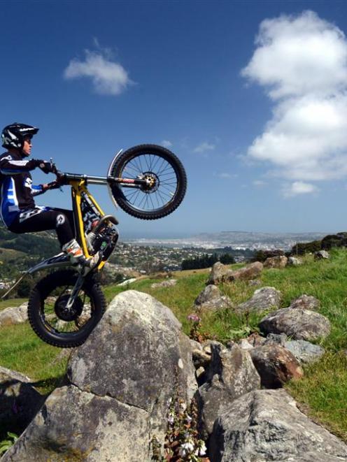 Trials rider Blake Fox (19) gets in some rock-hopping practice in Northeast Valley last week....