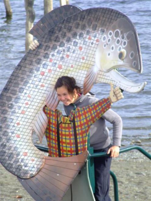 Kara-Mae Taylor (13), of Invercargill, poses for a photo with the 3m-high trout contraption...