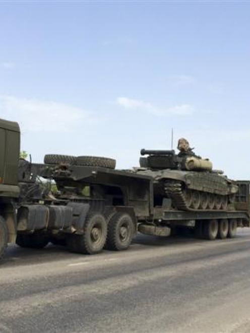 Trucks transport tanks along a road near the Russian southern town of Matveev Kurgan, near the...