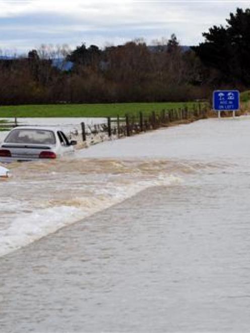 Two cars were swept off Gropers Bush-Thornbury Rd in Southland yesterday, when their drivers...