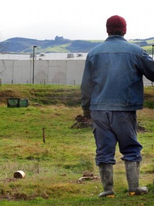 Two inmates take a break from working on the dairy farm at the Otago Corrections facility.