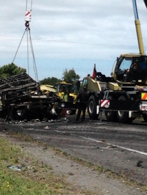 Two large trucks - a B-train and a semi-trailer - and a Nissan vehicle were involved in the crash...