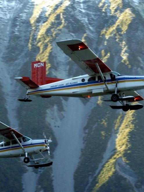 Two ski planes take to the air at Mt Cook, where pilots fly around mountainous terrain every day....