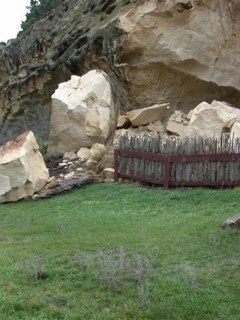 Two tourists stay well clear of a massive rock fall covering the centre portion of the Takiroa...