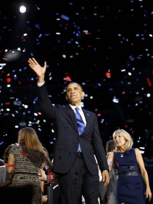 US President Barack Obama celebrates after his victory speech on election night in Chicago. Photo...