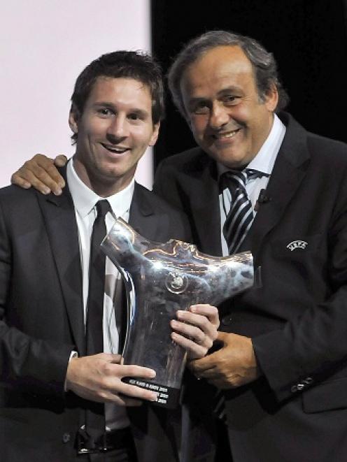 UEFA President Michel Platini (R) poses with Barcelona's Lionel Messi, who was named the Best...