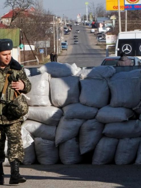 Ukrainian border guards stand at a checkpoint at the border with Moldova breakaway Transnistria...