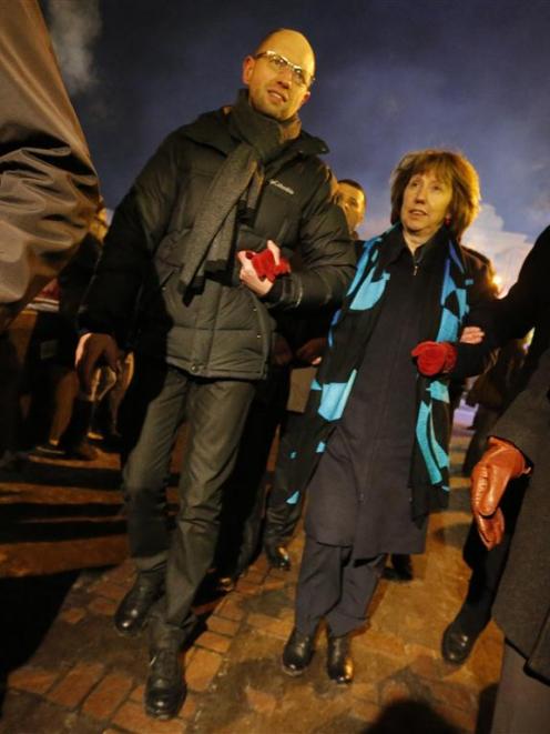 Ukrainian opposition leader Arseny Yatsenyuk and EU foreign policy chief Catherine Ashton walk in...