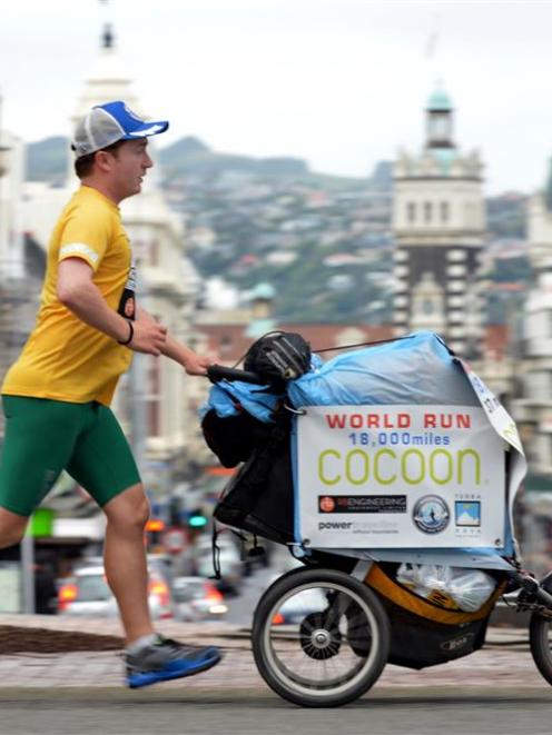 Ultra-marathon runner Kevin Carr runs through Dunedin on the New Zealand leg of his attempt to...