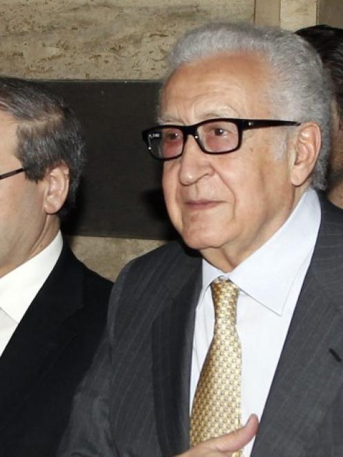 UN envoy Lakhdar Brahimi (C) returns to a hotel after meeting Syria's President Bashar al-Assad...