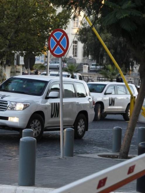 UN vehicles transporting chemical weapons experts return to their hotel in Damascus. REUTERS...