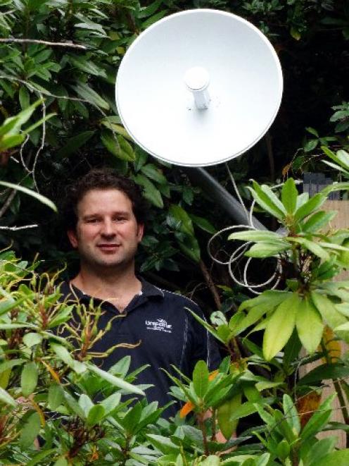 Unifone managing director Travis Baird installs an internet receiver at the offices of the...