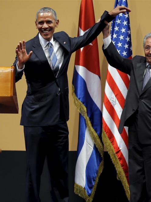 United States President Barack Obama and Cuban President Raul Castro gesture after a news...