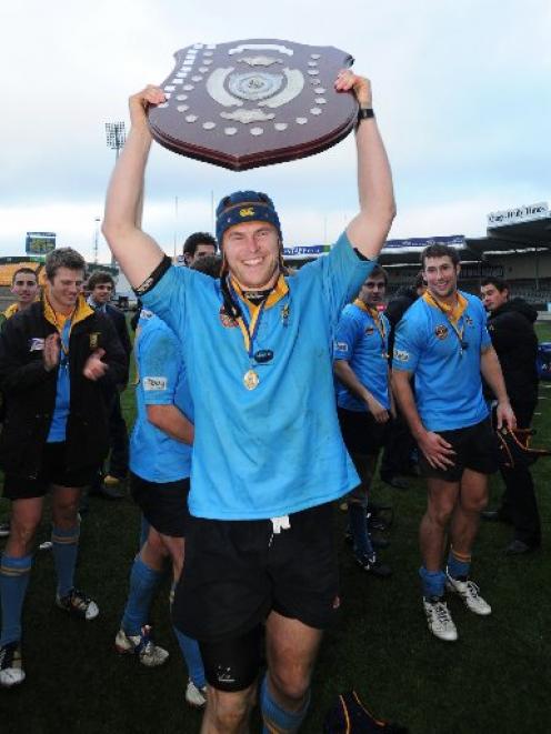 University A captain Brad Cameron lifts the shield after his side won the Dunedin premier club...