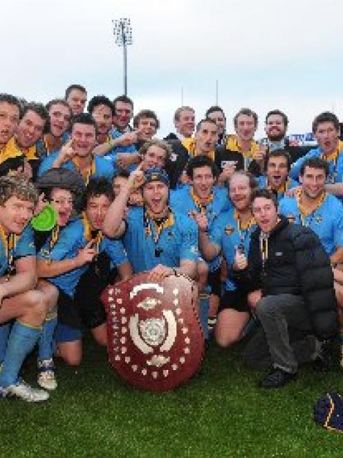 University A players and officials celebrate their 48th Dunedin premier rugby banner after...