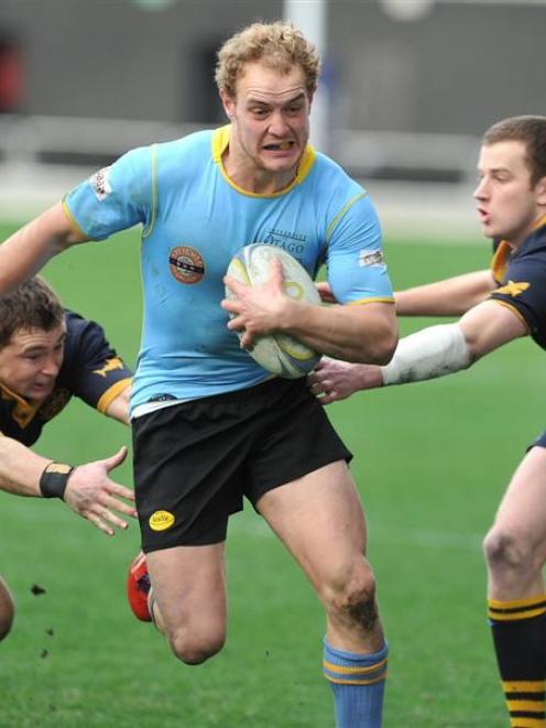 University centre Matt Faddes is tackled by Dunedin wing Rowan McKenzie (left) and fullback Liam...