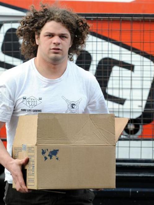 University of Canterbury Engineering Society president Carl Shrimpton unloads the cans of food it...