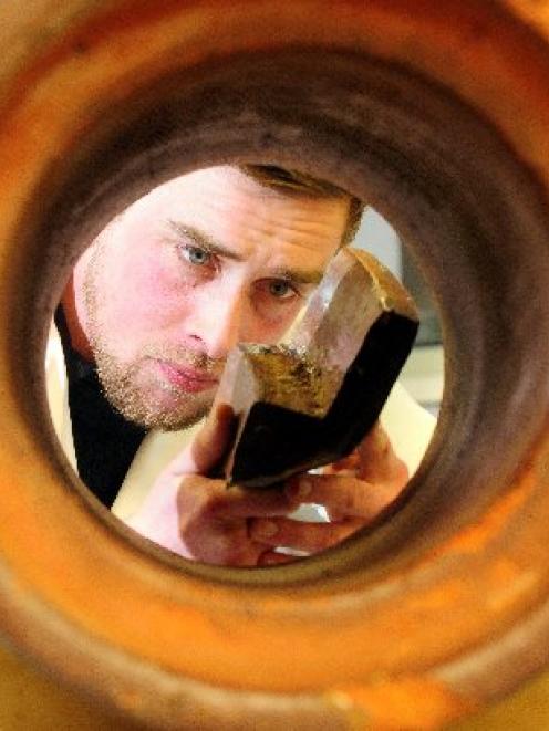 University of Otago archaeology masters student Hamish Williams studies drainpipes from the 1860s...