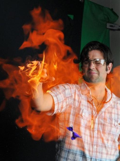 University of Otago chemistry PhD student Dan Hutchinson uses his flaming hand to burst and...