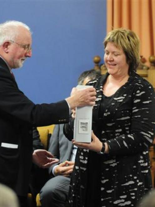 University of Otago  Freemasons scholarships committee chairman Alan Jackson  presents  an...
