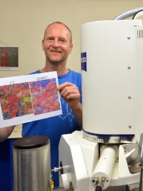 University of Otago geologist Prof David Prior, pictured beside an electron microscope, displays...