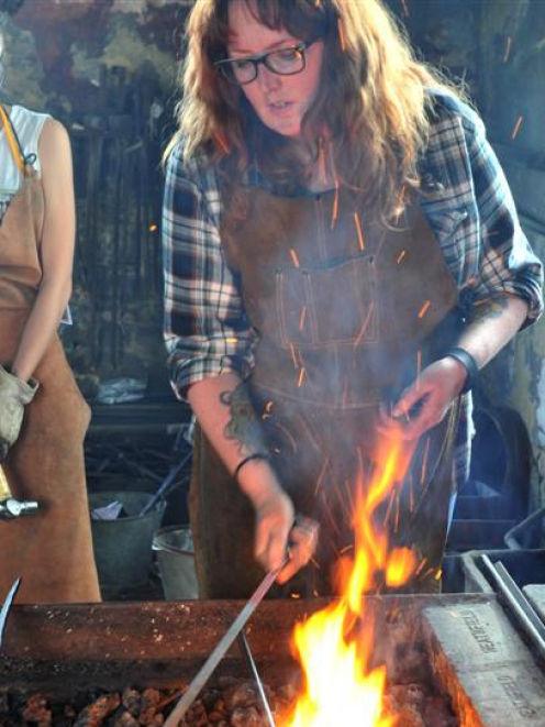 University of Otago psychology PhD student Ann Cronin (39) demonstrates her blacksmithing skills...