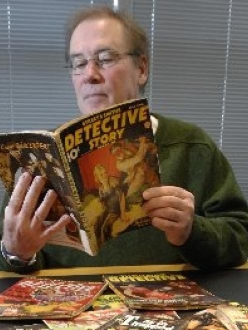 University of Otago special collections librarian Donald Kerr with some of the pulp fiction...