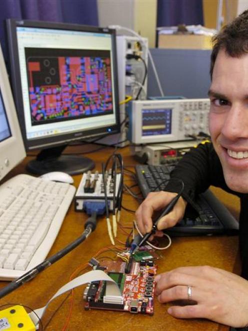 University of Otago student Keith Payne tests the power consumption of a cellphone module for a...