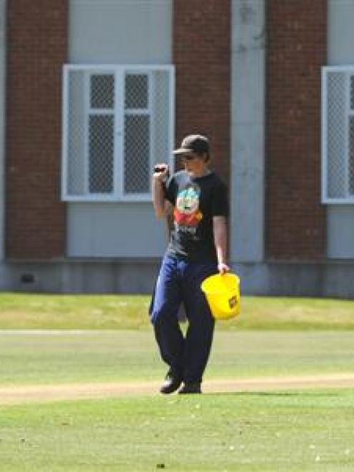 University Oval groundstaff work on the pitch during the match yesterday. Photo by Peter McIntosh.
