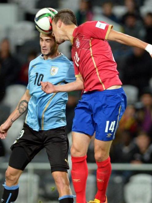 Uruguay's Gaston Pereriro (left) and Serbia's Vukasin Jovanovic compete for the ball during their...
