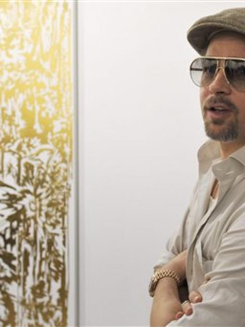 US actor Brad Pitt looks at the art work "end of knowledge" (24K gold on primed linen, 2008-2009)...