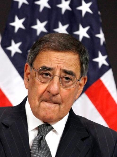 US Defense Secretary Leon Panetta listens to a question about photographs that were published in...
