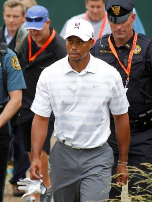 US golfer Tiger Woods walks to the 18th green during a practice round for the 2013 US Open at the...