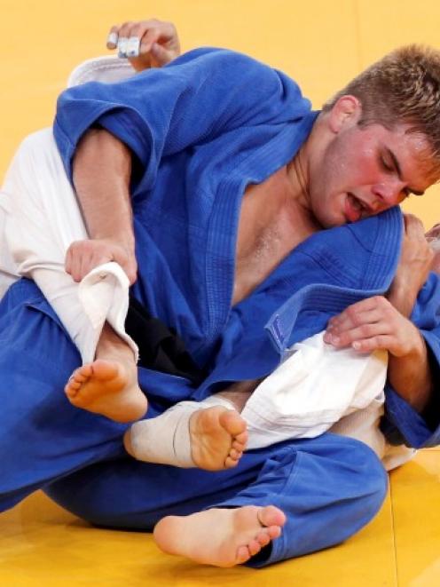 US judoka Nicholas Delpopolo (blue) fights South Korea's Wang Ki-Chun during the men's -73kg...