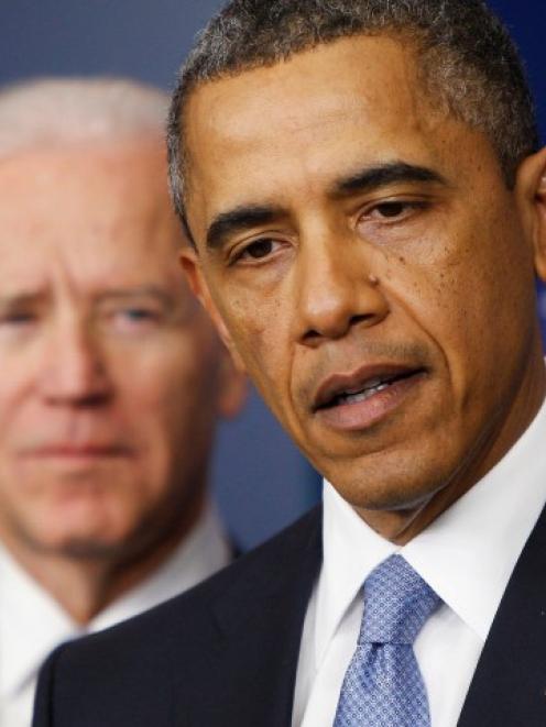 US President Barack Obama delivers remarks next to Vice President Joe Biden (L) after the House...