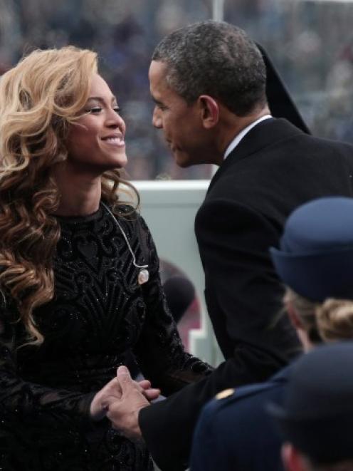 US President Barack Obama greets singer Beyonce after she performed the National Anthem during...