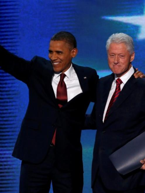 US President Barack Obama (L) joins former president Bill Clinton onstage after Clinton nominated...