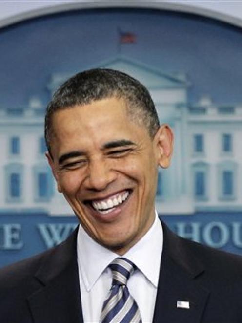 US President Barack Obama laughs in the White House as he speaks to reporters about the...