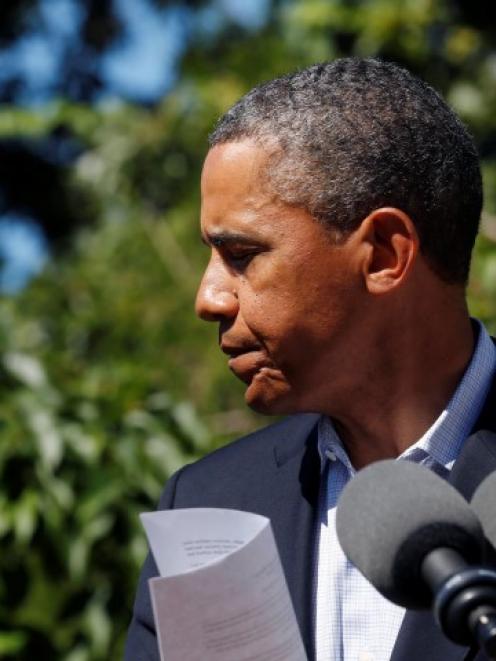 US President Barack Obama steps back after speaking about the violence in Egypt while at his...