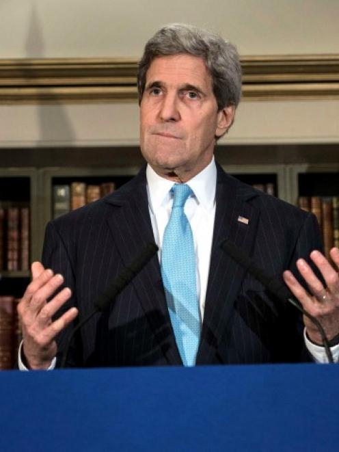 US Secretary of State John Kerry pauses while speaking during a news conference in London where...