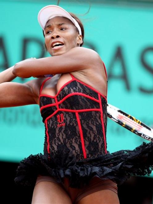 USA's Venus Williams returns the ball to Spain's Arantxa Parra Santonja during their second round...