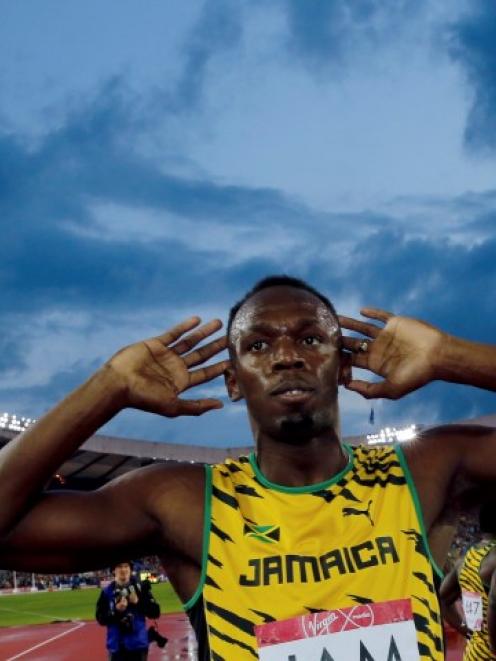 Usain Bolt gestures after Jamaica won the men's 4x100m relay final. REUTERS/Suzanne Plunkett